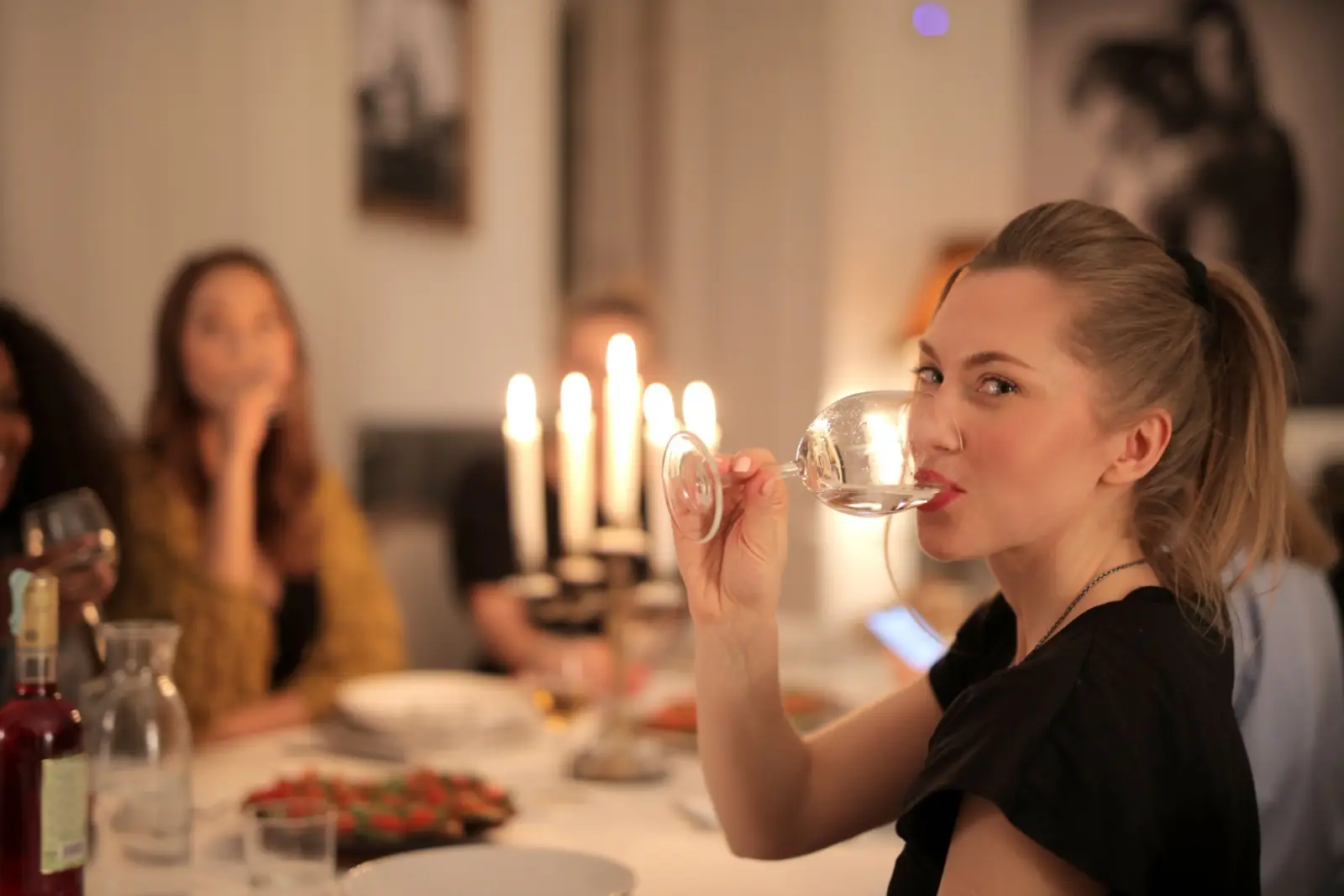 A guest at a candlelit dinner party