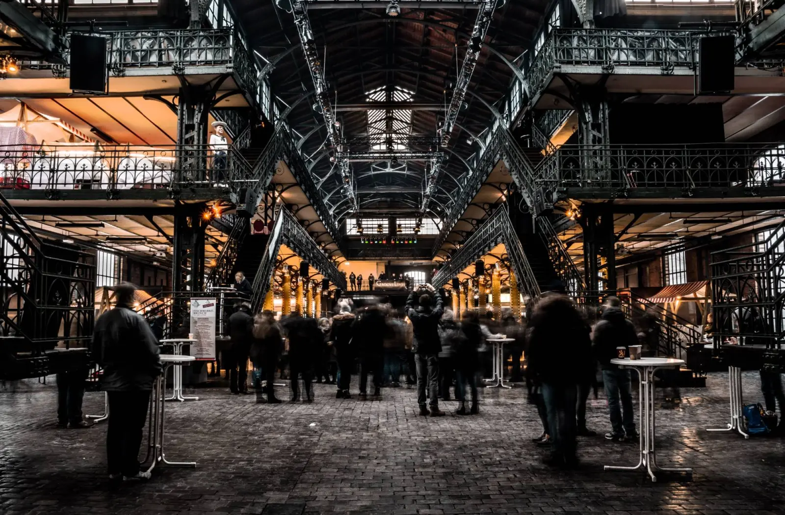 People in a busy covered market hall